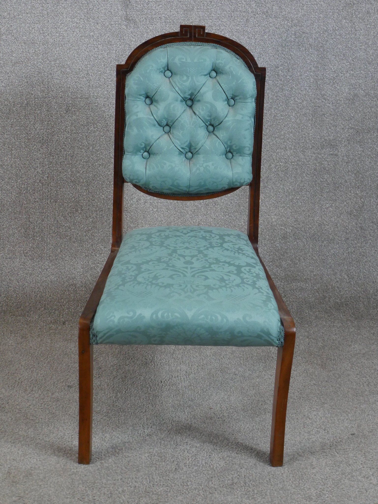 A 19th/early 20th century mahogany framed blue damask button back child's chair raised on sabre