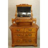 A late 19th/early 20th century pine mirror back dressing chest with three long drawers raised on