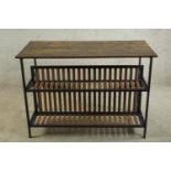 A contemporary metal framed and hardwood console table with slatted shelves below raised on square