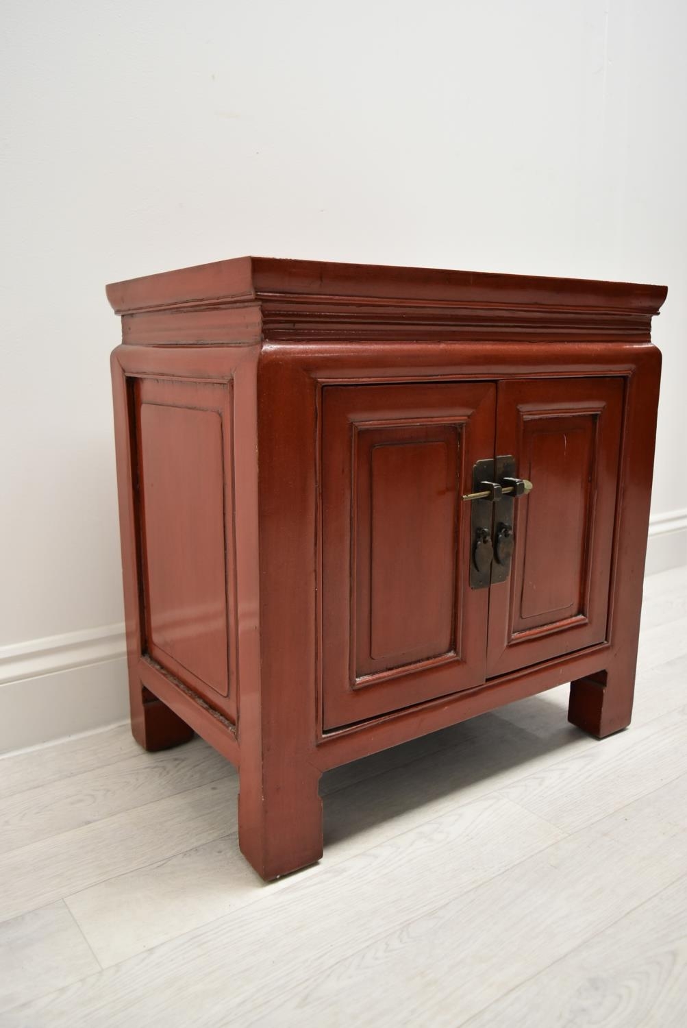 A Chinese style red painted twin door bedside cupboard opening to reveal shelves and single - Image 2 of 7