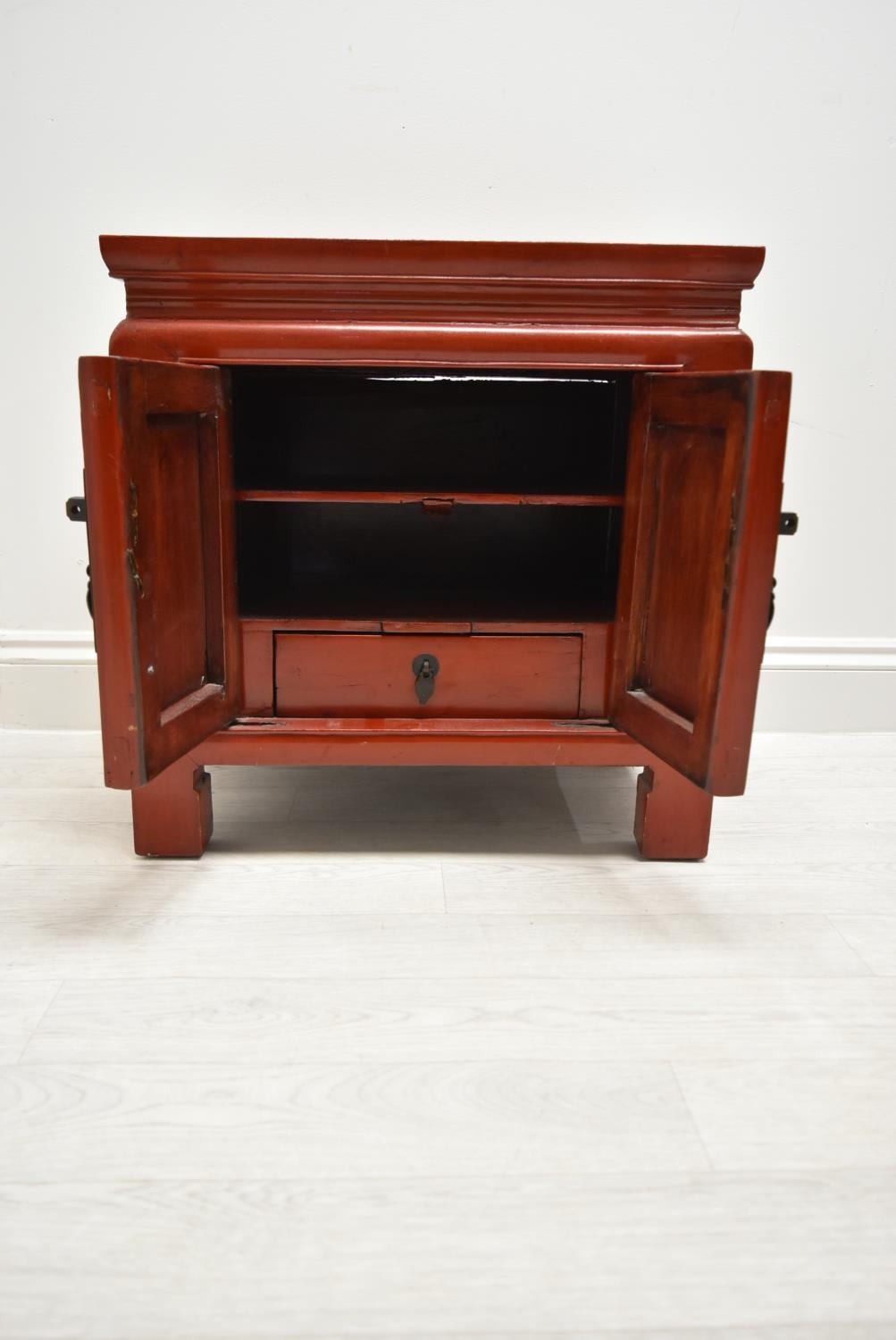 A Chinese style red painted twin door bedside cupboard opening to reveal shelves and single - Image 4 of 7