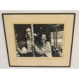 Indistinctly signed; Family at the Fair, a mounted black and white photograph, framed. H.46 W.54cm