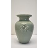 A Chinese green celadon crackle glaze baluster vase with incised mythical creature decoration. H.