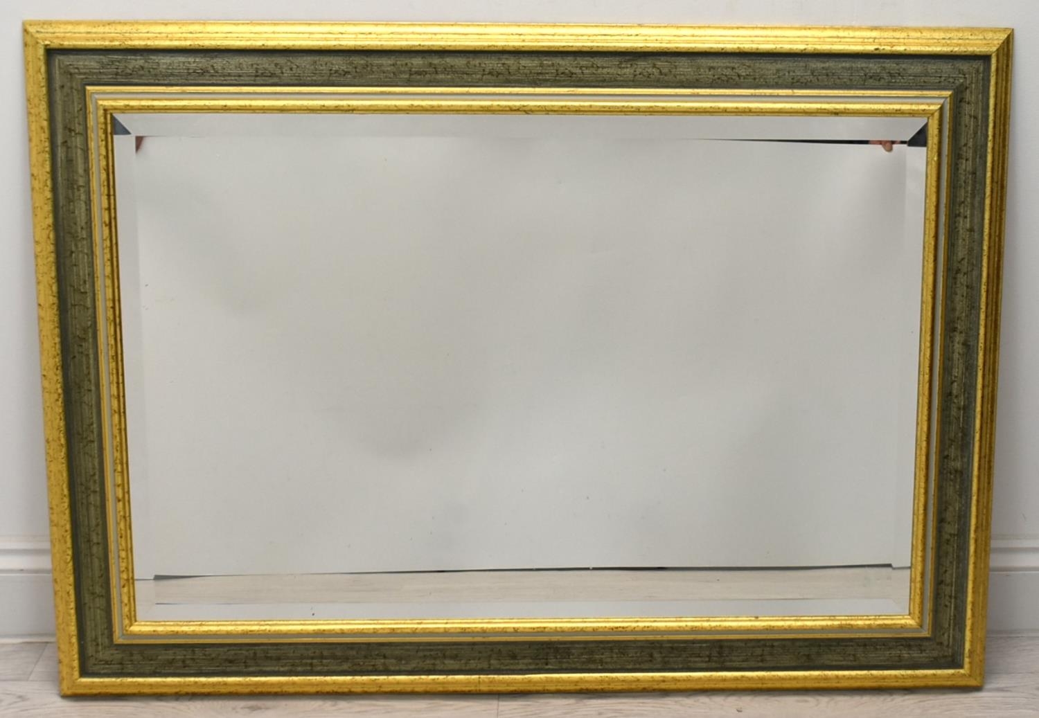 A contemporary gilt framed rectangular wall mirror. H.74 W.104cm