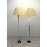 A contemporary pair of slender brass standard lamps raised on stepped circular bases. H.158cm