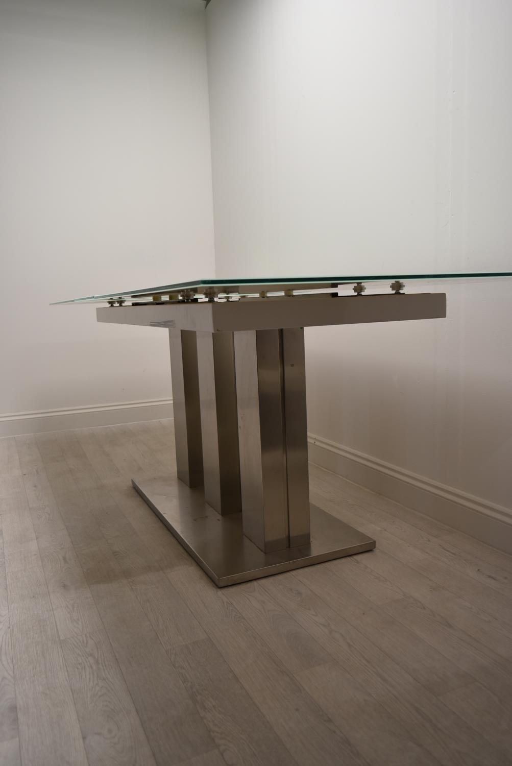 A contemporary extending glass dining table on brushed metal base. H.76 W.221 D.90cm - Image 5 of 21