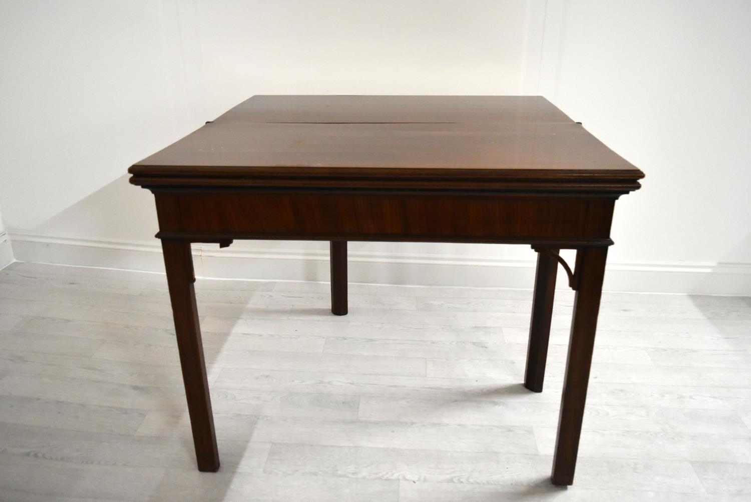 A George III mahogany rectangular fold over table raised on square supports. H.75.5 W.92.5 D.45.