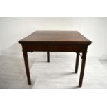 A George III mahogany rectangular fold over table raised on square supports. H.75.5 W.92.5 D.45.