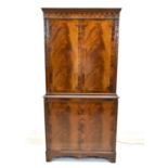 An early 20th century Georgian style inlaid mahogany twin door display cabinet opening to reveal