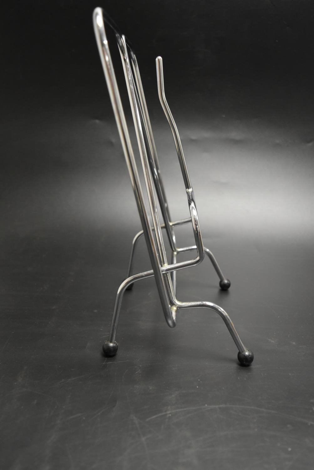 A silver plated modernist magazine rack raised on pad feet together with a chrome plated magazine - Image 6 of 6