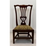 A 19th century mahogany pierced splat back nursing chair with upholstered drop in seat raised on