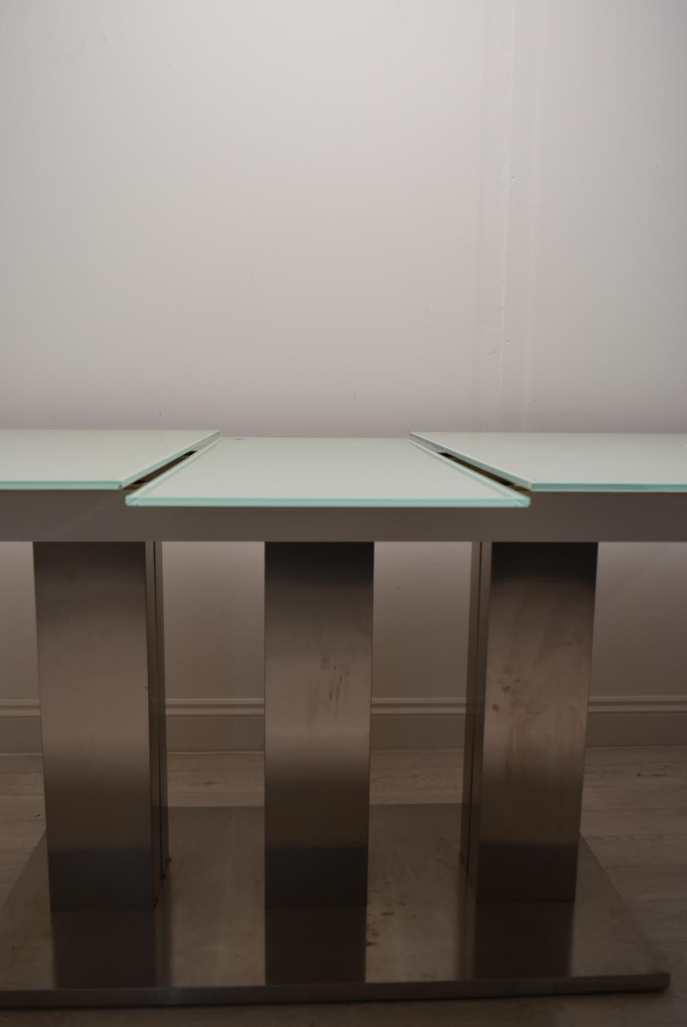 A contemporary extending glass dining table on brushed metal base. H.76 W.221 D.90cm - Image 10 of 21