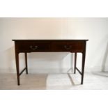 An Edwardian inlaid mahogany two drawer hall table raised on tapering supports terminating in pad