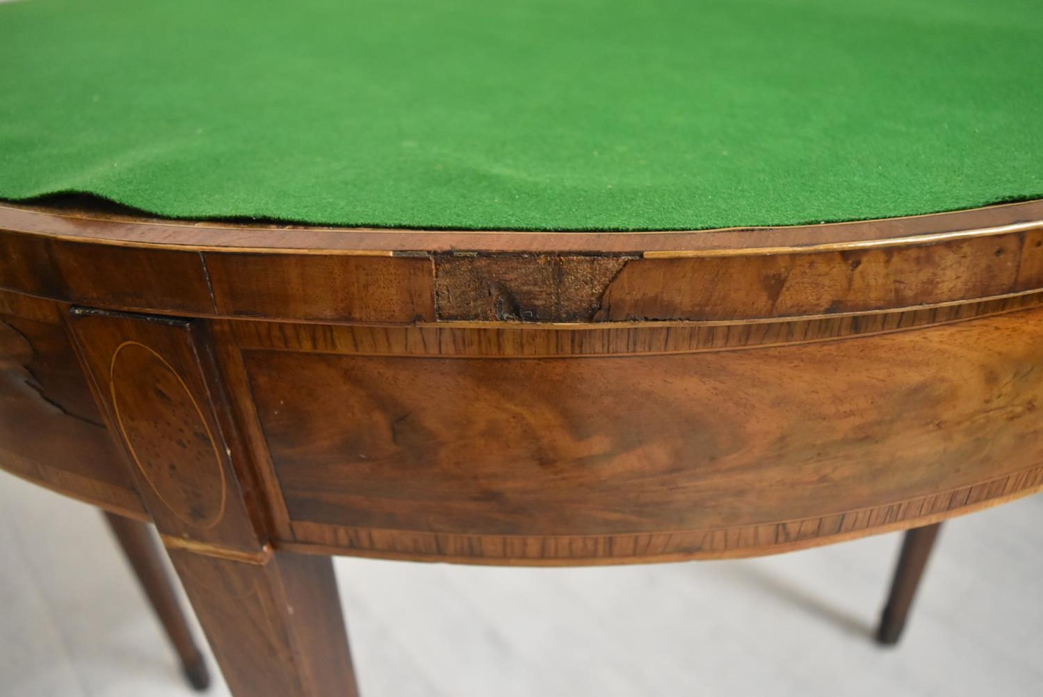 A George III cross banded mahogany fold over demi lune games table, raised on square tapering - Image 8 of 12