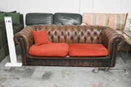 A Chesterfield two seater sofa in brown leather deep buttoned upholstery. H.70 x W.200 x D.82cm