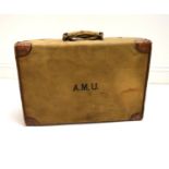 An early 20th century canvas covered crocodile skin effect gentlemen's vanity case embossed with