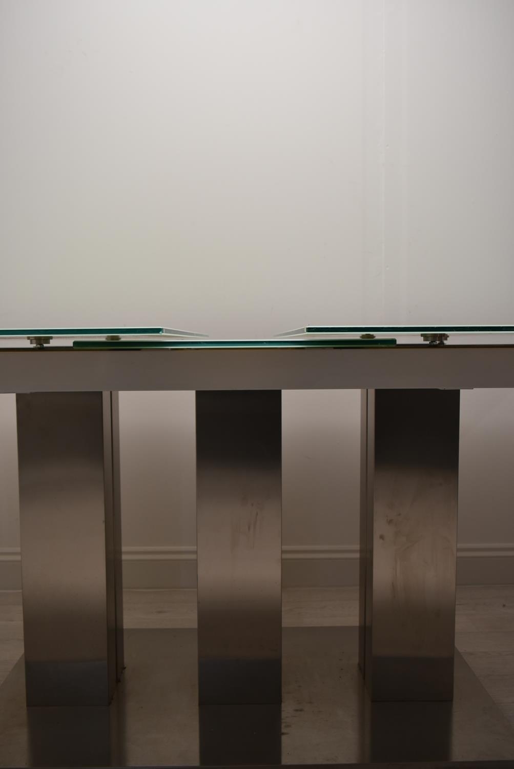 A contemporary extending glass dining table on brushed metal base. H.76 W.221 D.90cm - Image 11 of 21