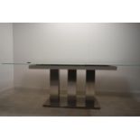 A contemporary extending glass dining table on brushed metal base. H.76 W.221 D.90cm