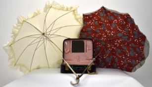 Two 20th century ladies parasols together with a ladies travelling vanity case by Lancôme.