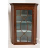 A George III mahogany single door corner cupboard with dentil cornice and single astragal glazed