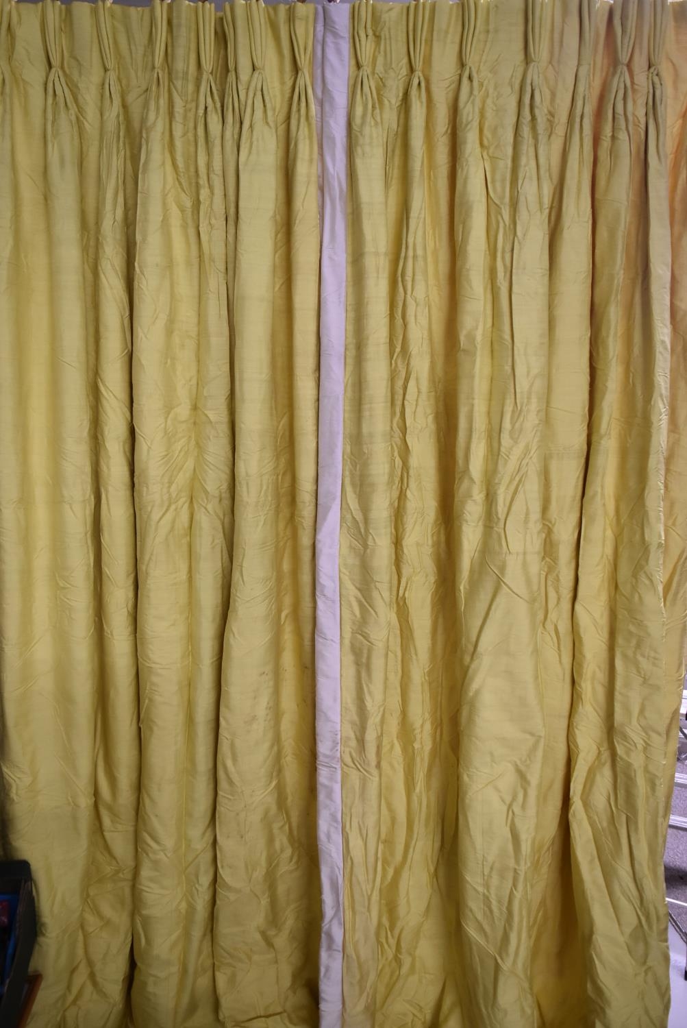 A pair of bright yellow silk pinch pleated interlined curtains. H.318 W.105cm