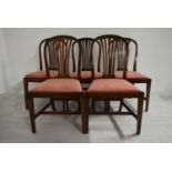 A set of five mahogany framed hoop and pierced splat back dining chairs with drop in seats raised on