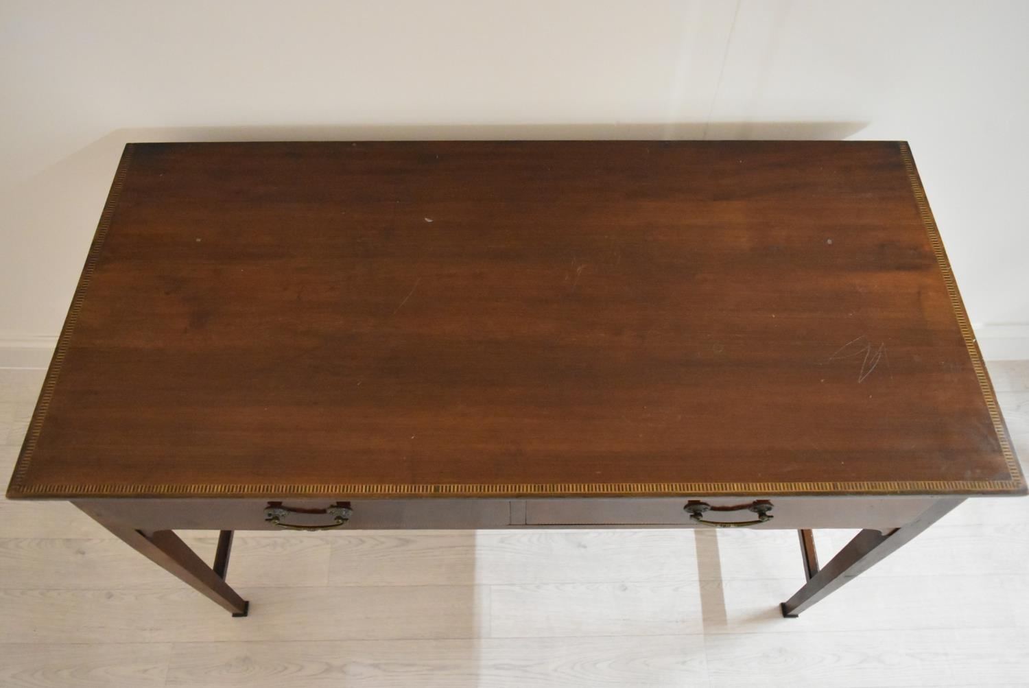 An Edwardian inlaid mahogany two drawer hall table raised on tapering supports terminating in pad - Image 2 of 14