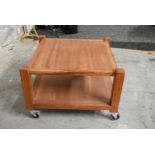 A contemporary hardwood low table on casters. H.48 x W.72 x D.72cm