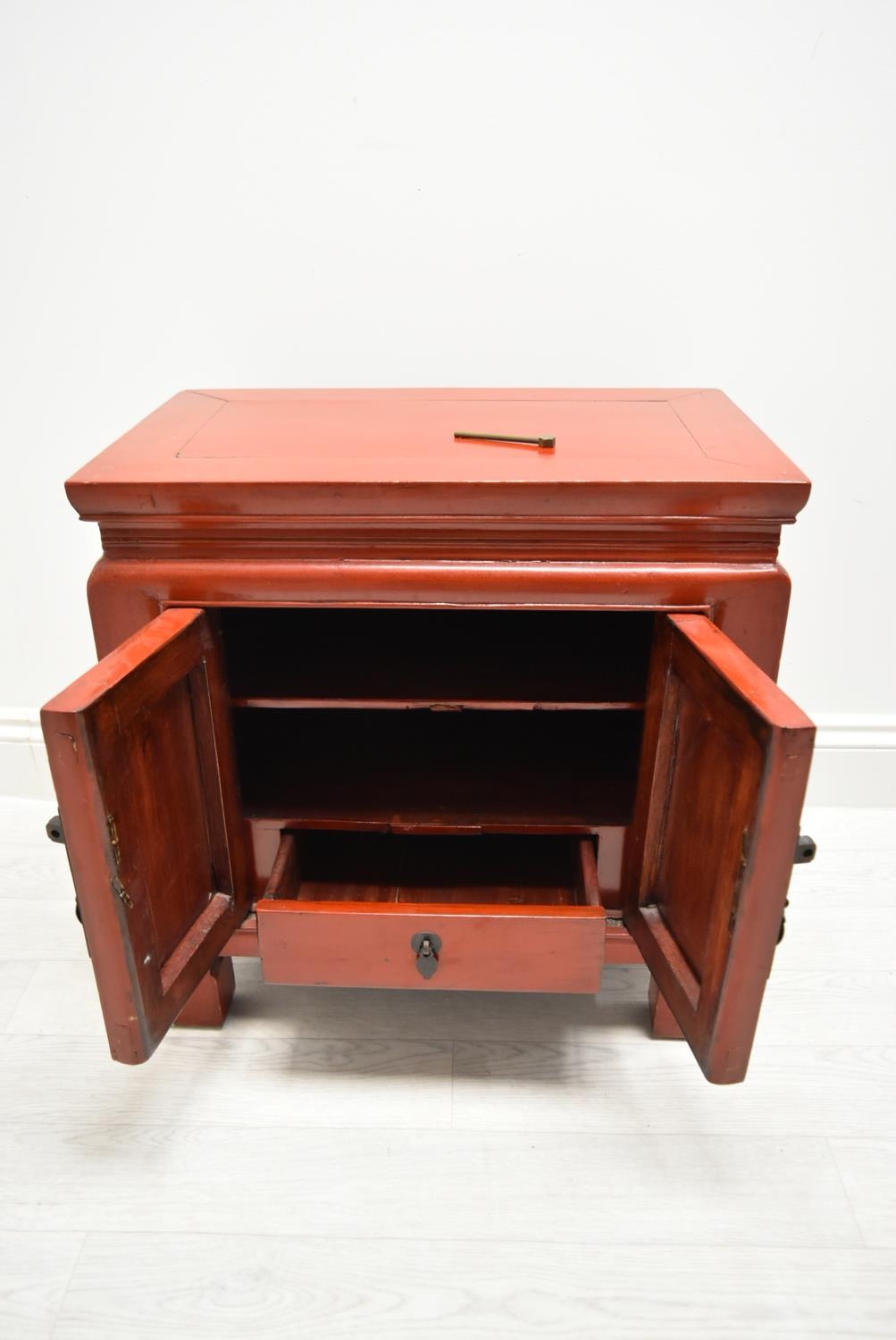 A Chinese style red painted twin door bedside cupboard opening to reveal shelves and single - Image 5 of 7