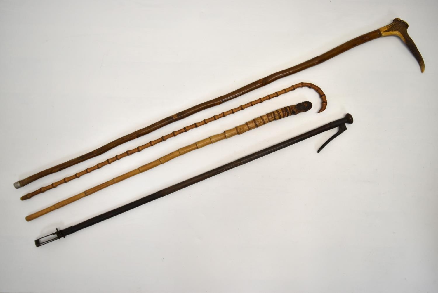 An early 20th century bamboo effect walking stick, together with a shepherds crook, a bamboo