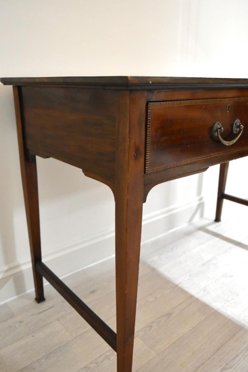 An Edwardian inlaid mahogany two drawer hall table raised on tapering supports terminating in pad - Image 10 of 14