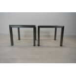 A pair of square brushed metal framed coffee side tables with glass top. Some chips to glass and one