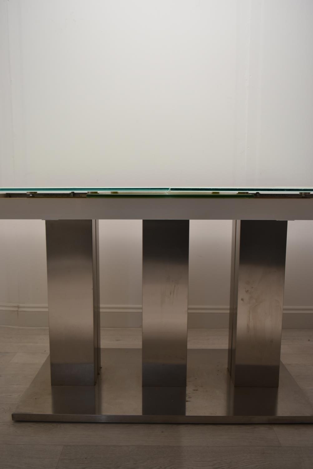 A contemporary extending glass dining table on brushed metal base. H.76 W.221 D.90cm - Image 13 of 21