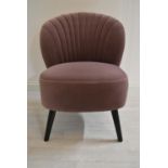 A contemporary shell back upholstered chair upholstered in purple velvet velour fabric raised on