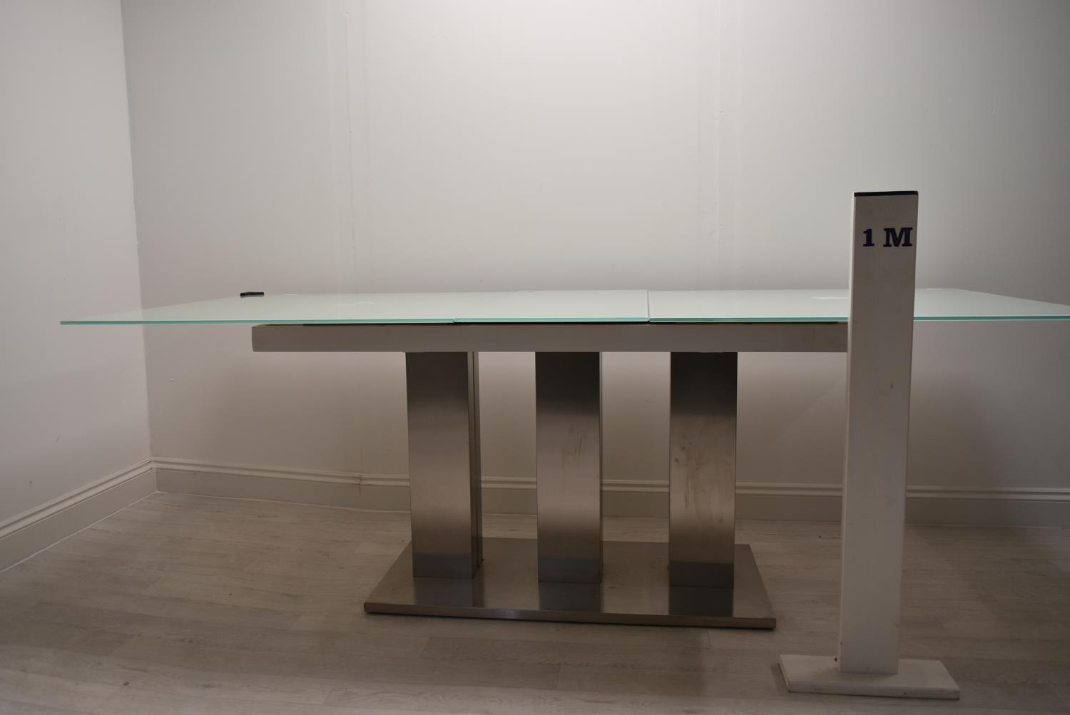 A contemporary extending glass dining table on brushed metal base. H.76 W.221 D.90cm - Image 3 of 21