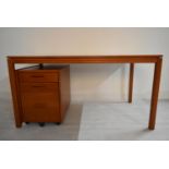 A contemporary oak plank top desk raised on square supports complete with mobile pedestal three