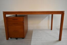 A contemporary oak plank top desk raised on square supports complete with mobile pedestal three