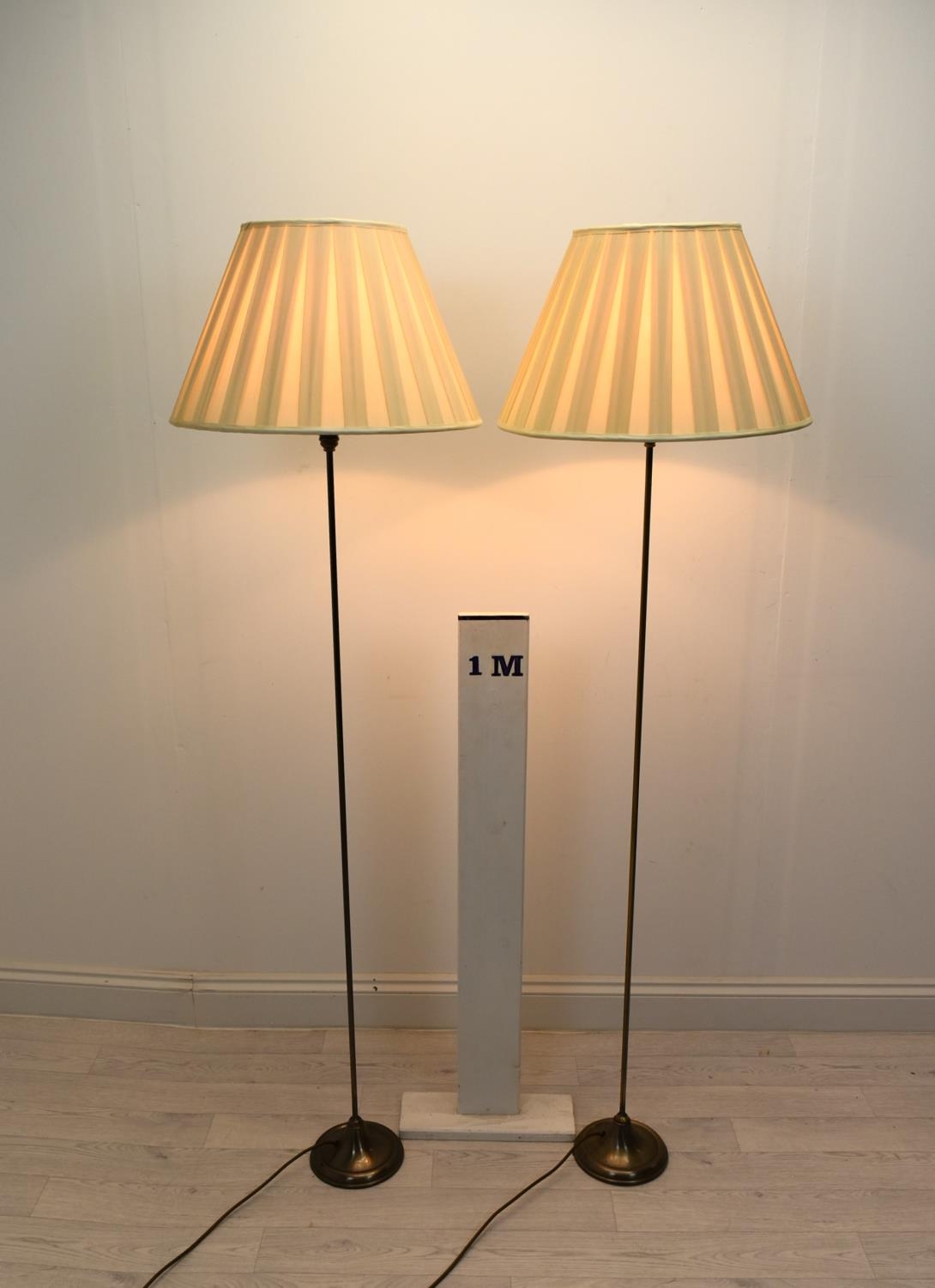 A contemporary pair of slender brass standard lamps raised on stepped circular bases. H.158cm - Image 2 of 2