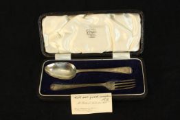 Silver spoon and fork in case made by W. F. Ranger, London. With note addressed to owner and their
