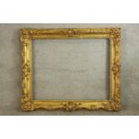 An impressive 19th/early 20th century gilt painted picture frame with floral decoration. H.103 W.