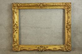 An impressive 19th/early 20th century gilt painted picture frame with floral decoration. H.103 W.