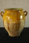 A contemporary drip glazed twin handled studio pottery vase. H.30cm.