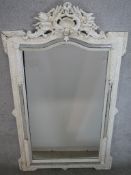 A 20th century carved white painted framed mirror, with applied carved decoration. H.155 W.95 D.12cm