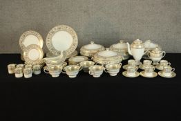 An extensive Wedgwood Gold Florentine W4219 part dinner and tea service to include cups, saucers and