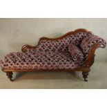 A 19th century mahogany show framed upholstered chaise longue raised on turned supports