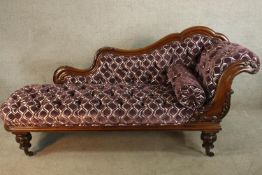 A 19th century mahogany show framed upholstered chaise longue raised on turned supports