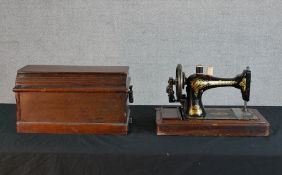 A cased early 20th century Singer sewing machine.