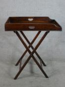 A 19th century mahogany butlers tray raised on folding stand. H.88 W.76 D.53cm