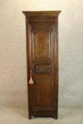 A late 19th/early 20th century French single door hall cupboard, opening to reveal shelves raised on