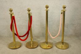 Two contemporary brass and rope entrance barriers, raised on circular feet. H.101cm. (largest)
